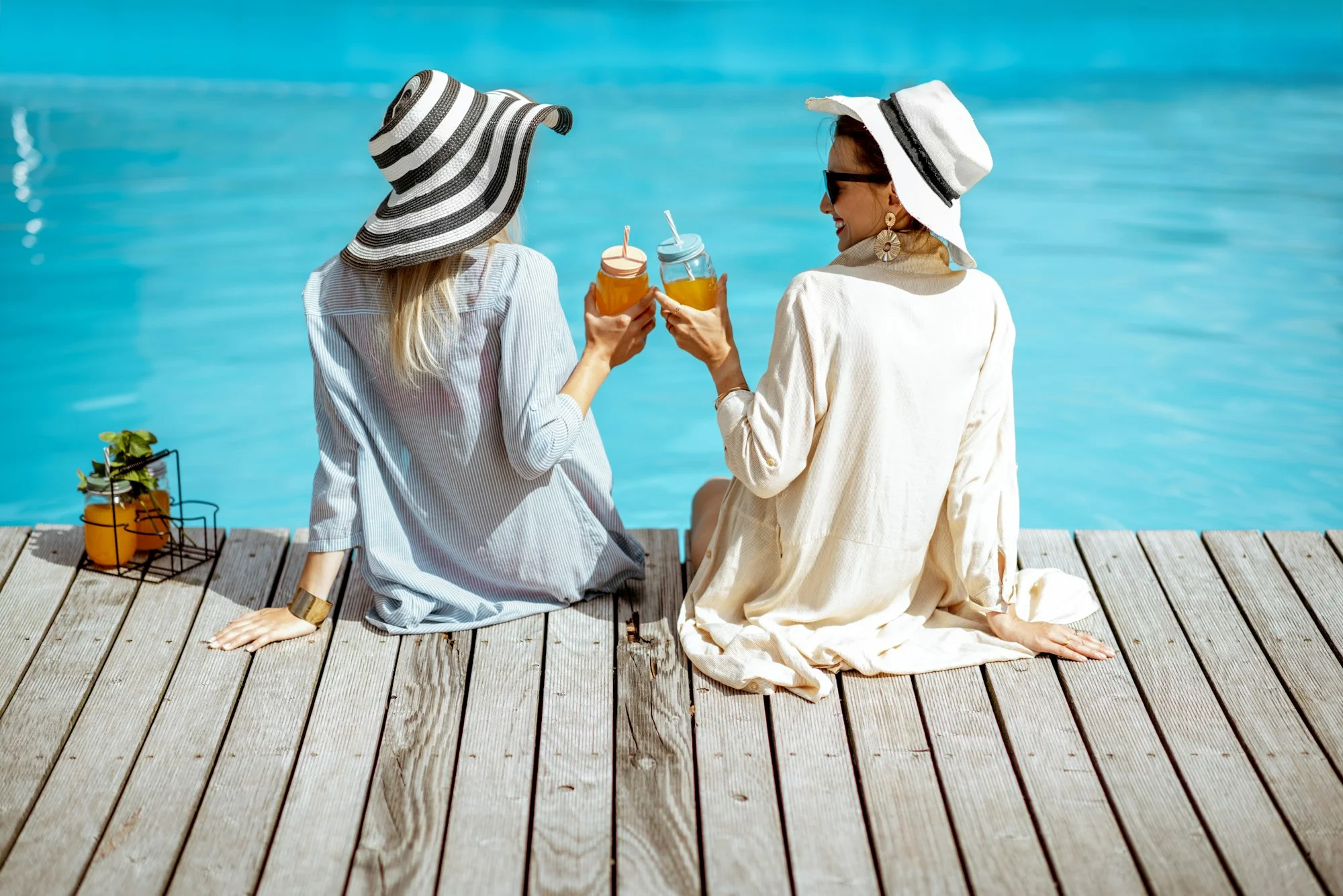 Girlfriends on the swimming pool outdoors