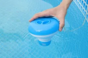 Worker hands isinfection and chlorination of water in the pool.